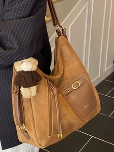 Brown faux suede large shoulder tote bag with a bear charm and fringe details