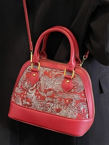 Minimalist red leather shell bag with white embroidery and golden hardware crossbody strap