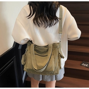 Olive green canvas tote bag with multi-pockets and mini coin purse on a female model