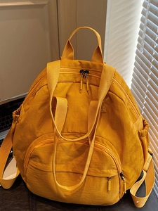 Ginger yellow high-capacity casual backpack for women with water-resistant fabric and sleek design