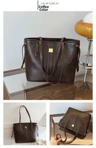 Detail of coffee brown PU leather tote bag with gold metal plaque and side drawstring