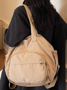 Large beige nylon backpack with functional side drawstring pockets and durable fabric