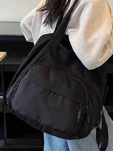 Large black nylon travel backpack with spacious zipper pocket for casual daily use