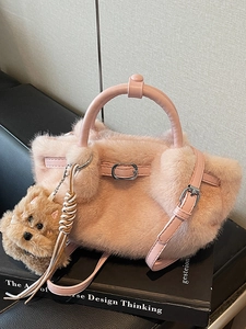 Pink plush bucket bag with soft faux fur texture and a cute brown dog keychain charm