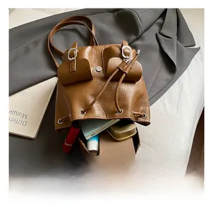 Internal view of brown retro PU leather backpack showing storage for phone and notebook