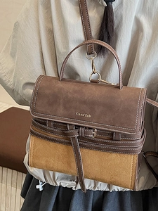 Vintage brown and tan crossbody bag shown on a model for autumn fashion trends