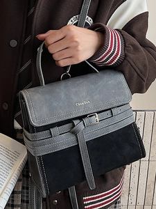 Retro two-tone crossbody bag with top handle and decorative buckle in grey and black suede