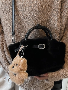 Faux fur bucket bag with leather handles and a plush dog pendant for autumn winter fashion