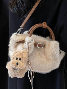 Plush tote bag with faux fur texture, leather handles, and top dog charm accessory