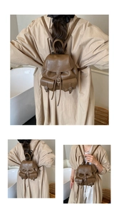 Detail view of retro brown faux leather backpack featuring drawstring and buckle pockets