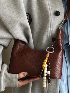 Dark brown woven shoulder bag with chic bead tassel for women in stylish hobo design