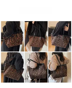 Detail showing the large leopard print tote bag with black straps and soft texture finish