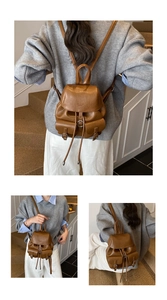 Detail view of brown vintage leather mini backpack with drawstring and silver metal buckles