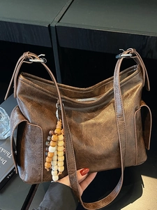 Minimalist vintage dark brown leather dumpling bag with decorative wooden bead tassel