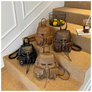Detail showing four retro faux leather backpacks in black, brown, and tan tones