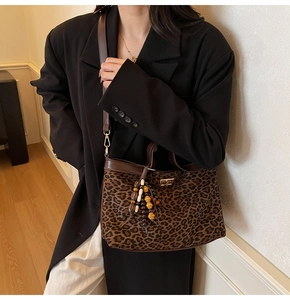 Detail der Schultertasche mit Leopardenmuster, böhmischer Holzperlenquaste und Lederbesatz