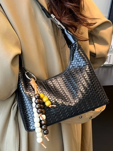 Chic black woven texture hobo bag with wood bead pendant for women in khaki coat