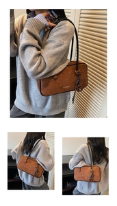 Detail of vintage brown suede shoulder bag with logo print and decorative fringe tassel