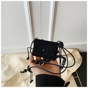 Close-up of black mini suede crossbody coin purse with silver button and wooden bead cord