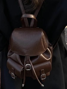 Deep brown retro faux leather backpack with front pockets and drawstring closure