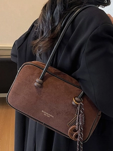 Brown suede underarm shoulder bag with chic pendants and brand logo for daily commute