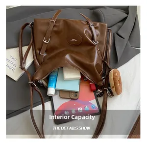 Brown faux leather tote bag with a donut charm showing large interior capacity