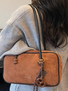 Brown suede underarm shoulder bag with wooden abacus and pretzel charms for women