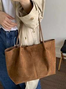 Brown faux suede large tote bag styled with beige trench coat for autumn fashion look