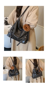 Detail of black faux leather backpack showing adjustable straps and plush donut pendant