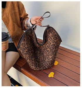 Macro detail of leopard print tote bag with brown leather handles in a retro autumn setting