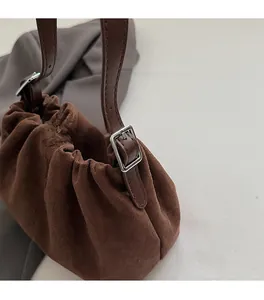 Detailed macro shot of premium silver adjustable buckle on dark brown suede handbag strap