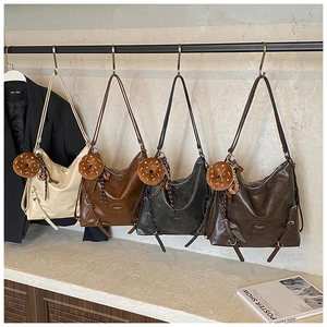 Macro detail of high-capacity tote bags in four colors with plush donut charms