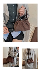 Close-up of pleated brown faux suede cloud bag with sleek dual-purpose shoulder straps