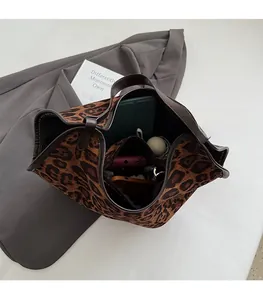 Top view of leopard print tote bag showing spacious interior with daily essentials