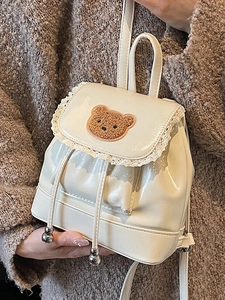 Creamy white PU leather mini drawstring backpack with lace trim and plush bear patch