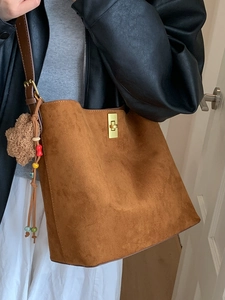 Retro brown suede tote bag with metal twist lock and star charm on shoulder strap