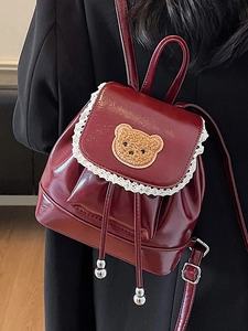 Deep red shiny leather mini backpack with lace trim and plush bear detail for girls