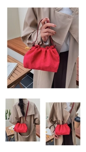 Three-way view of a red pleated suede dumpling bag featuring a stylish crossbody strap