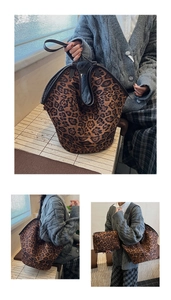 Detail view of large leopard print tote bag with brown straps and a matching small zipper pouch