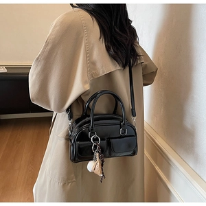 Classic black patent leather Boston bag with crossbody strap and front pockets