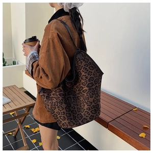 Detail of large leopard print tote bag featuring black trim and spacious autumn design