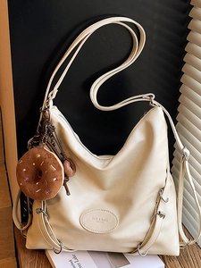 Chic cream-colored large tote bag with soft pleated texture and a cute donut charm