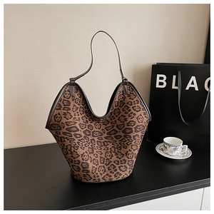 Chic leopard print tote bag placed on a modern black table with stylish coffee set