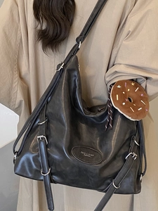 Black large capacity faux leather tote bag with metal buckle and plush charm for women