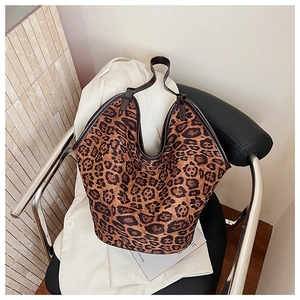 Close-up of leopard print tote bag with dark leather handles and premium stitching