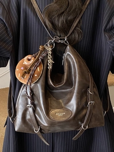 Vintage large brown hobo tote bag in glossy leather with a plush doughnut charm