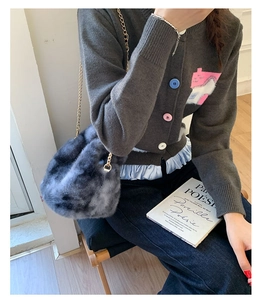 Close-up of a gradient grey faux fur chain bag with a stylish casual outfit