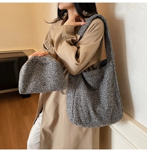 Détail du sac cabas gris en laine mélangée et pochette assortie sur un trench