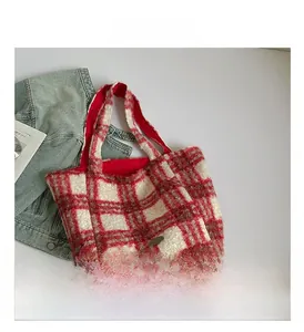 Detailed close-up of red and white checkered plush tote bag with soft wool texture