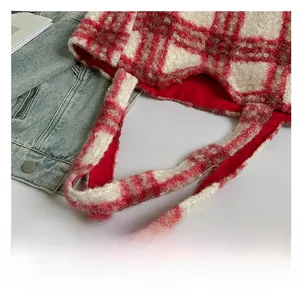 Close-up of red and white checkered plush tote bag with soft wool-like texture and red lining